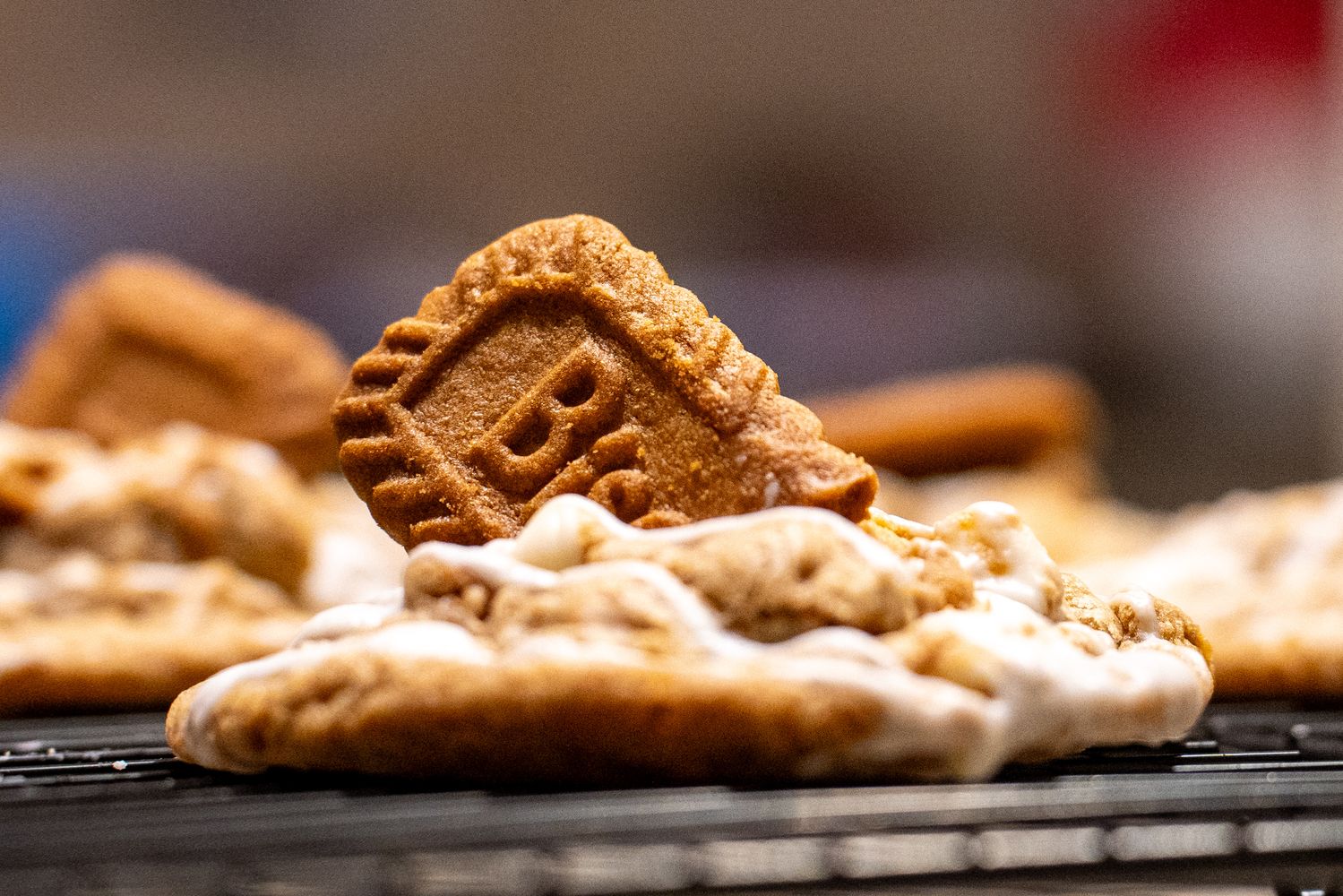 Low angle close up of a cookie butter cookie with a speculoos cookie standing on top